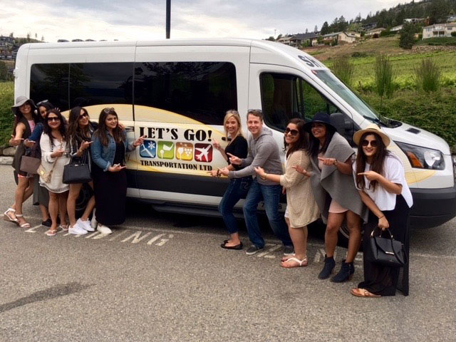 Wine tasting group in from of Let's Go Wine Tour Shuttle